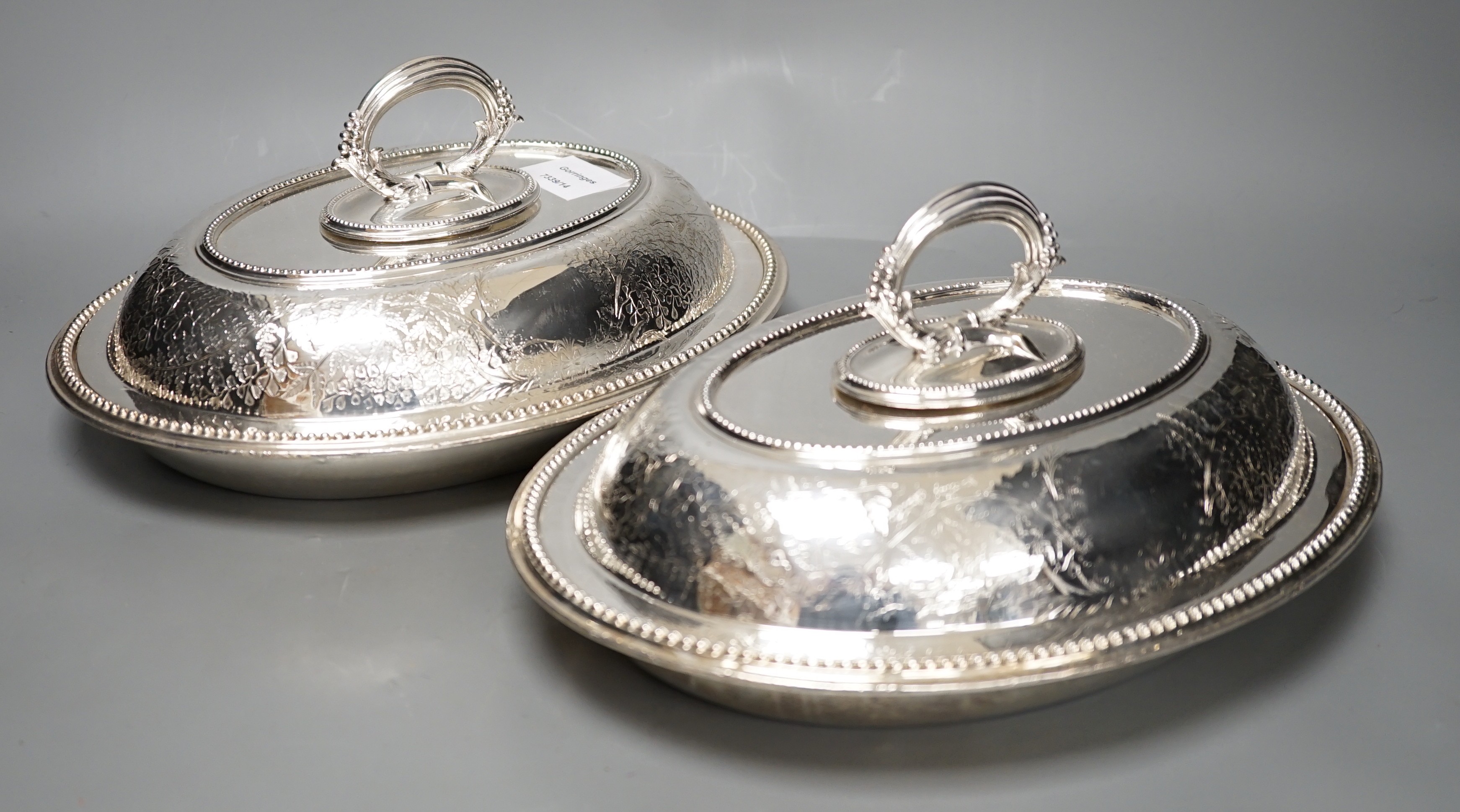 A pair of Edwardian plated engraved oval entree dishes and covers
